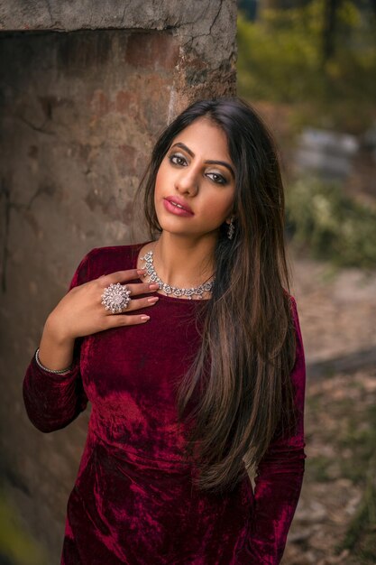 Portrait of young woman standing against rock