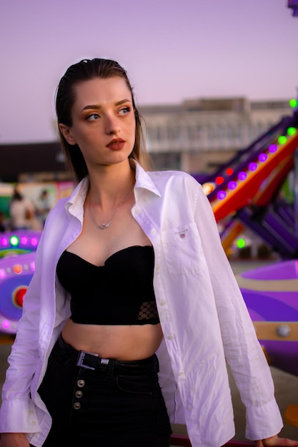 Portrait of young woman standing against sky