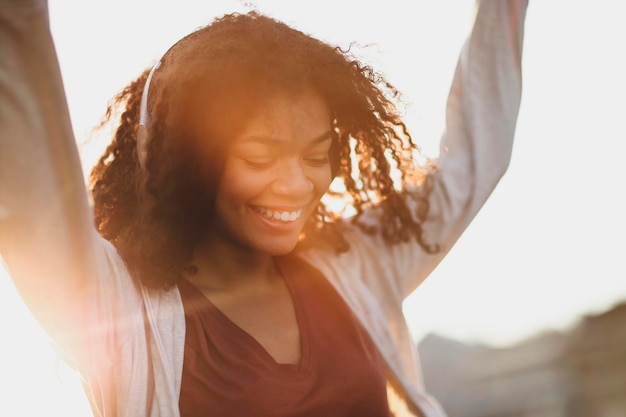 Portrait of young woman standing against sky