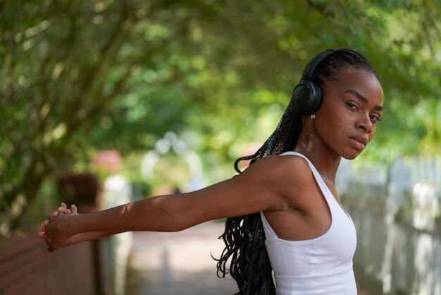 Portrait of young woman standing against trees