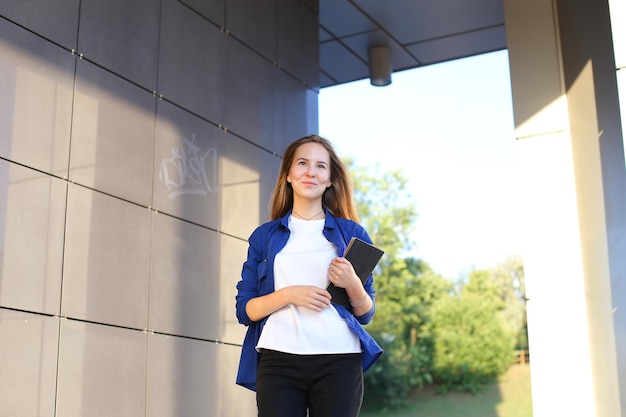 portrait of young woman standing against wall
