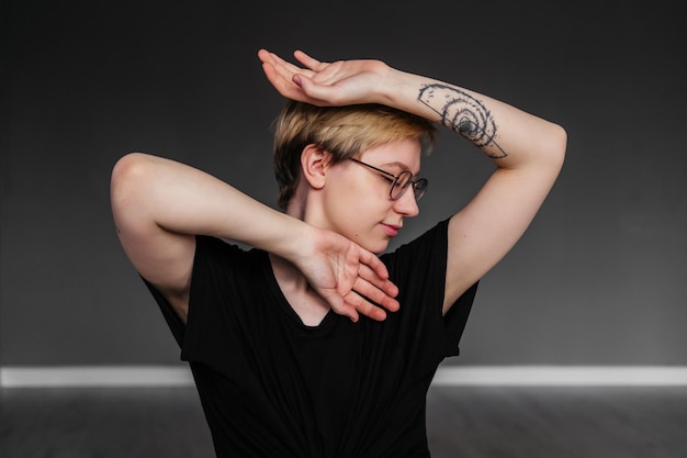 Portrait of young woman standing against wall