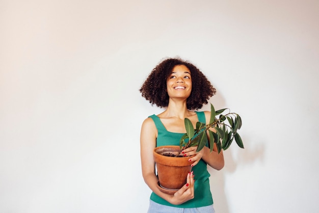 portrait of young woman standing against wall