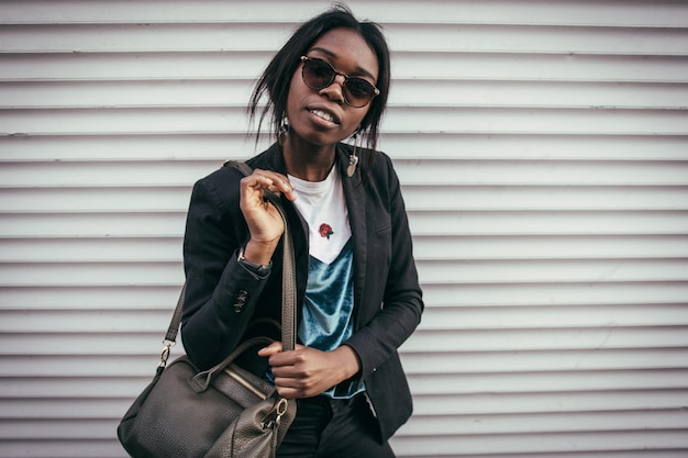 portrait of young woman standing against wall