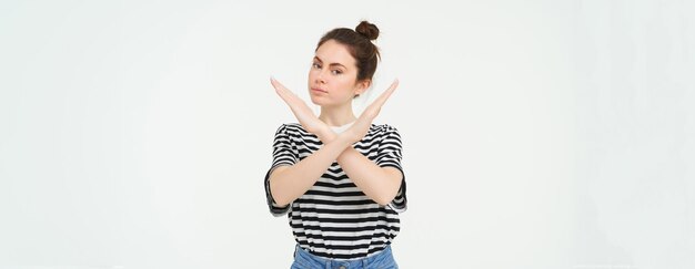 Portrait of young woman standing against white background