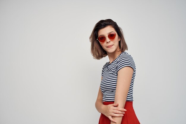 Portrait of young woman standing against white background