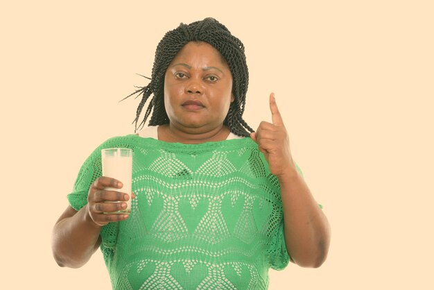 Portrait of young woman standing against white background