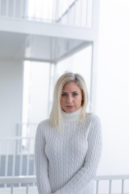 Photo portrait of young woman standing against window