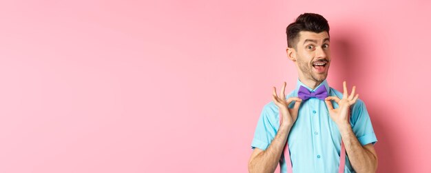 Portrait of young woman standing against yellow background