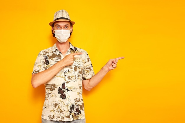 Portrait of young woman standing against yellow background