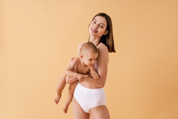 Portrait of young woman standing against yellow background