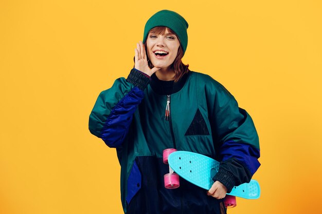 Portrait of young woman standing against yellow background