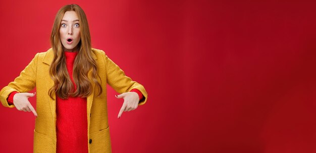 Photo portrait of young woman standing against yellow wall