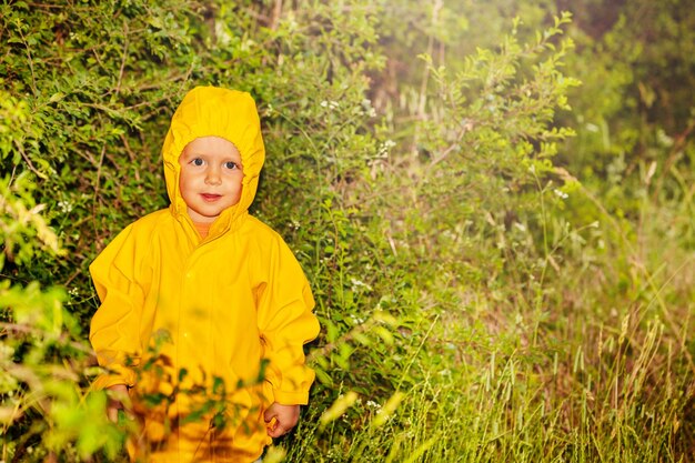 Portrait of young woman standing amidst plants