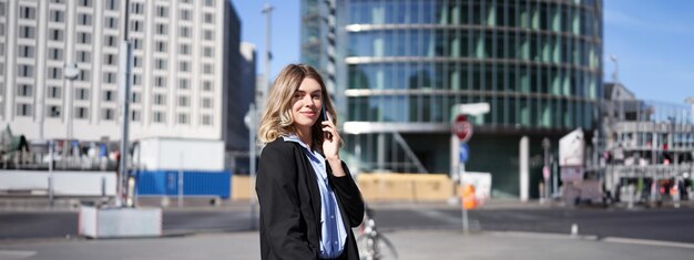 Portrait of young woman standing in city