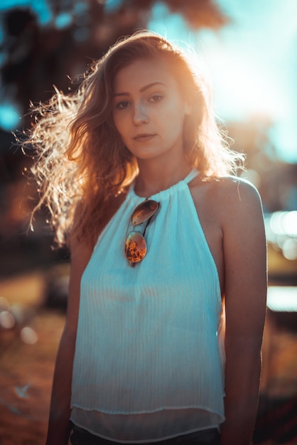 Portrait of young woman standing in city