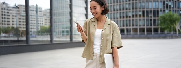 Portrait of young woman standing in city