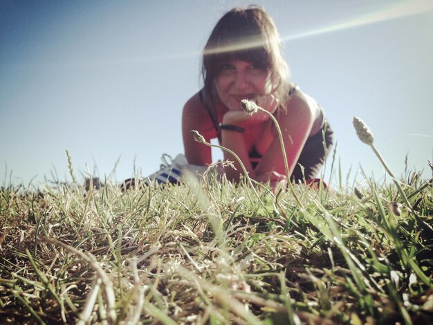 Portrait of young woman standing on field