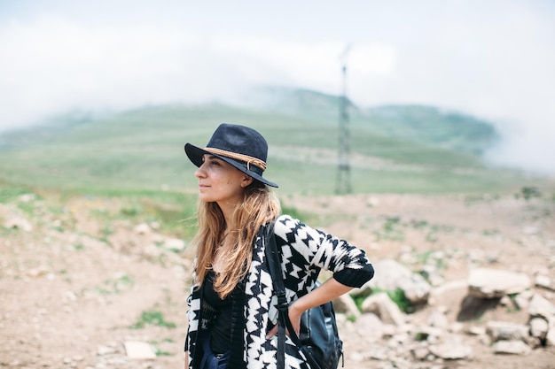 Portrait of young woman standing on field