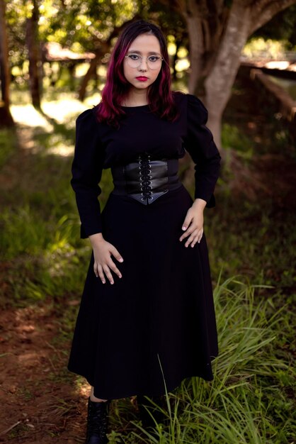 Portrait of young woman standing on field