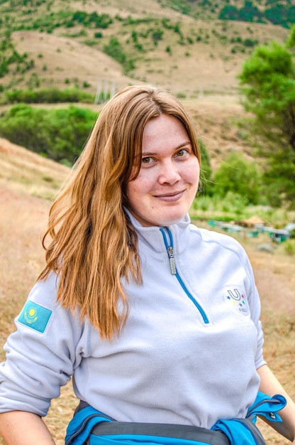 Portrait of young woman standing on field