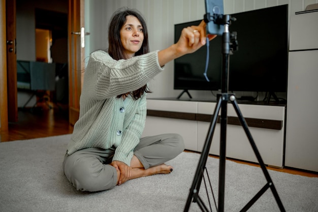portrait of young woman standing on floor at home