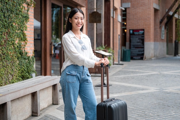 portrait of young woman standing on footpath