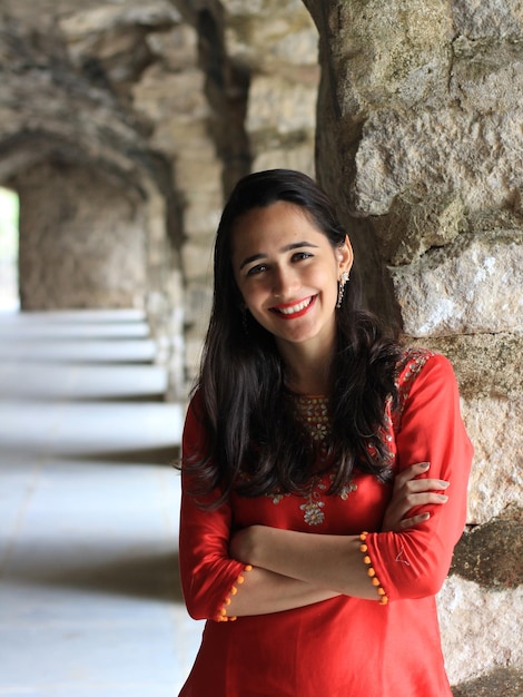 Portrait of young woman standing at historic place