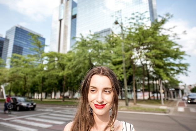 Portrait of a young woman standing on the modern office district background in Brussel city