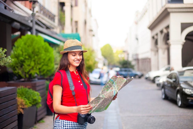 Portrait of young woman standing on street in city