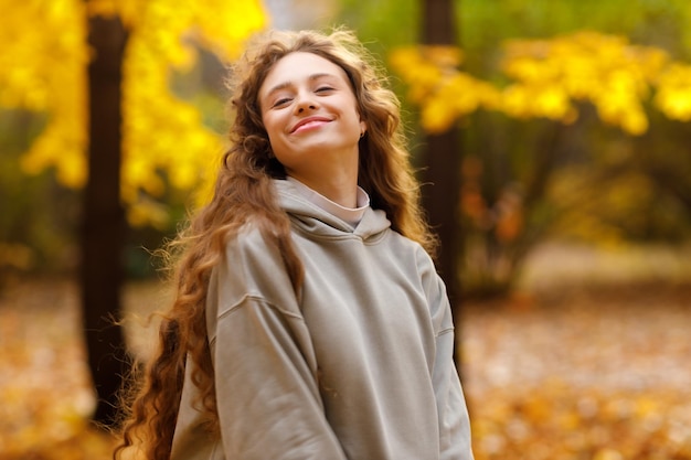 Portrait of young woman standing in sunflower