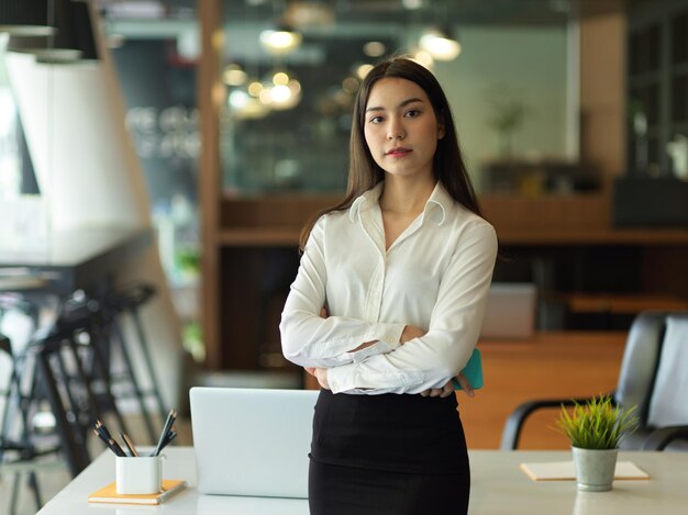 Portrait of a young woman standing on table