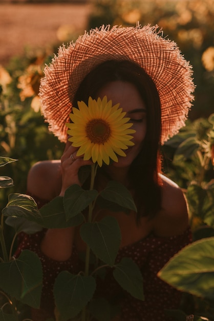 Portrait of a young woman in sunflower field