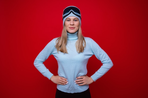 Portrait of a young woman in a sweater and ski goggles