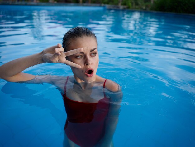 Portrait of young woman swimming in pool