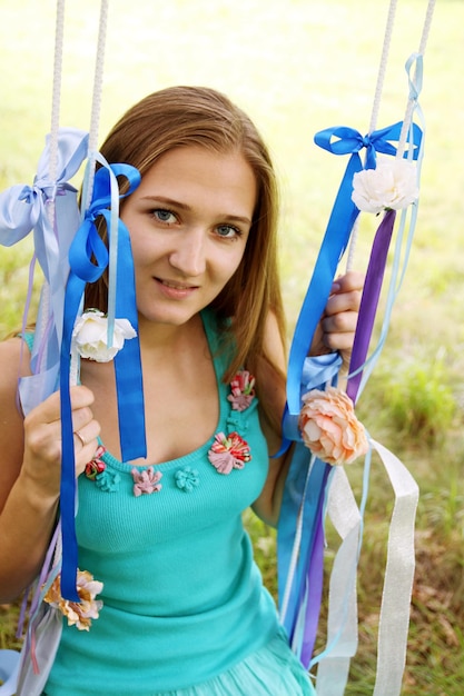 Photo portrait of a young woman on a swing