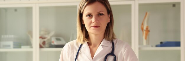 Portrait of a young woman at a table in a clinic a closeup concept diagnostics of health