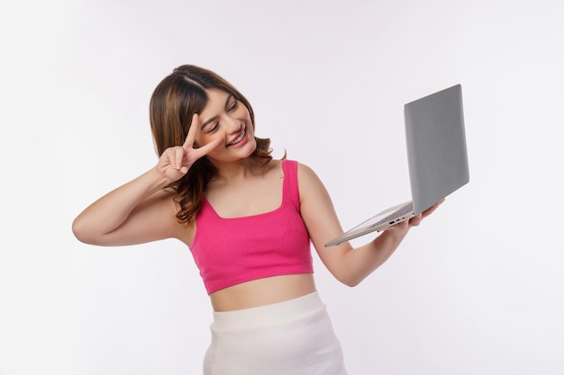 Photo portrait of young woman taking a photo with laptop computer isolated over white background