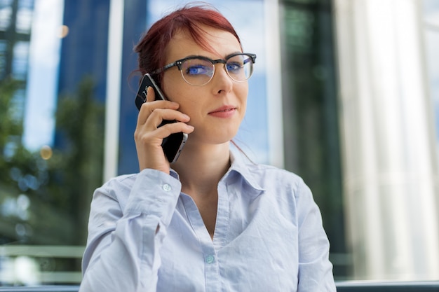 Portrait of a young woman talking on the phone