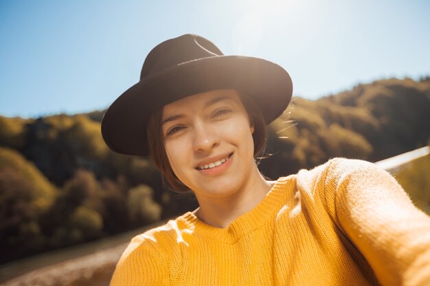 Portrait of young woman traveler on nature