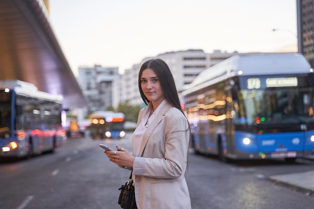 Portrait of young woman traveller walking by the street