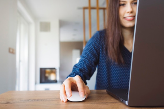 Portrait of young woman using laptop at home