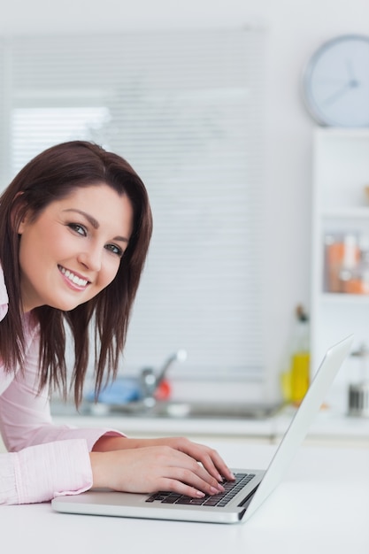 Portrait of young woman using laptop