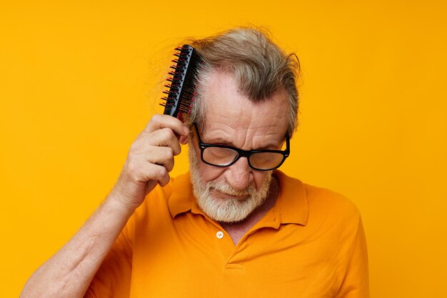 Portrait of young woman using mobile phone against yellow background