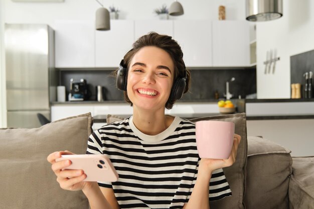 Portrait of young woman using mobile phone at home