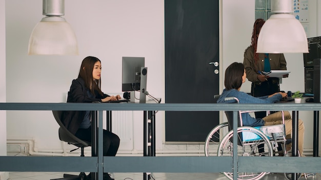 Portrait of young woman using mobile phone in office