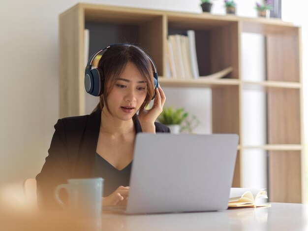 テーブルに座って電話を使っている若い女性の肖像画