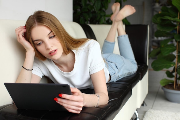 Portrait of a young woman using tablet computer