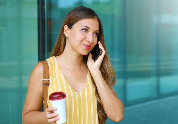 Portrait of young woman walking in the city