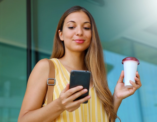 Portrait of young woman walking in the city